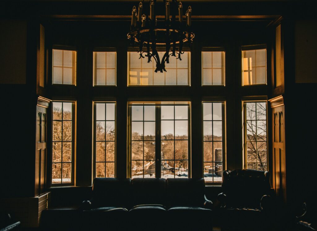Warm interior with large windows overlooking a scenic outdoor view.